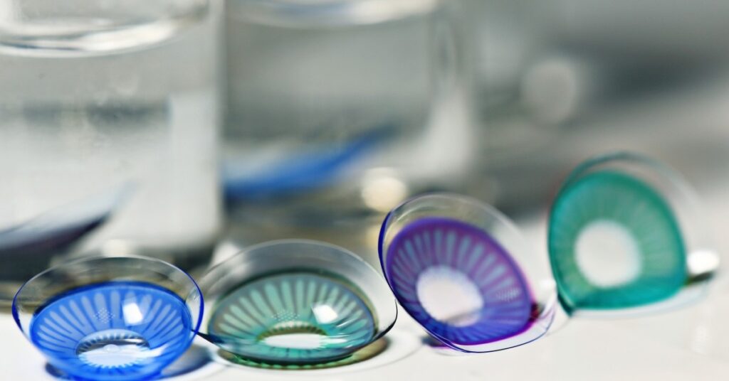 Colored contacts FAQs: Various colored contact lenses displayed with water in the background.