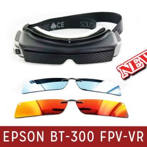 A black and silver pair of smart glasses with a thick black head strap. A pair of silver polarized clip-on lenses. A pair of orange-tinted polarized clip-on lenses.